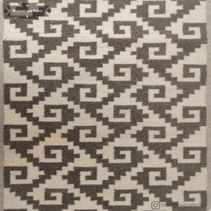Black rug with beige patterns that represent the stairs to the underworld